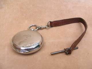 Top vier of closed compass and T bar leather strap